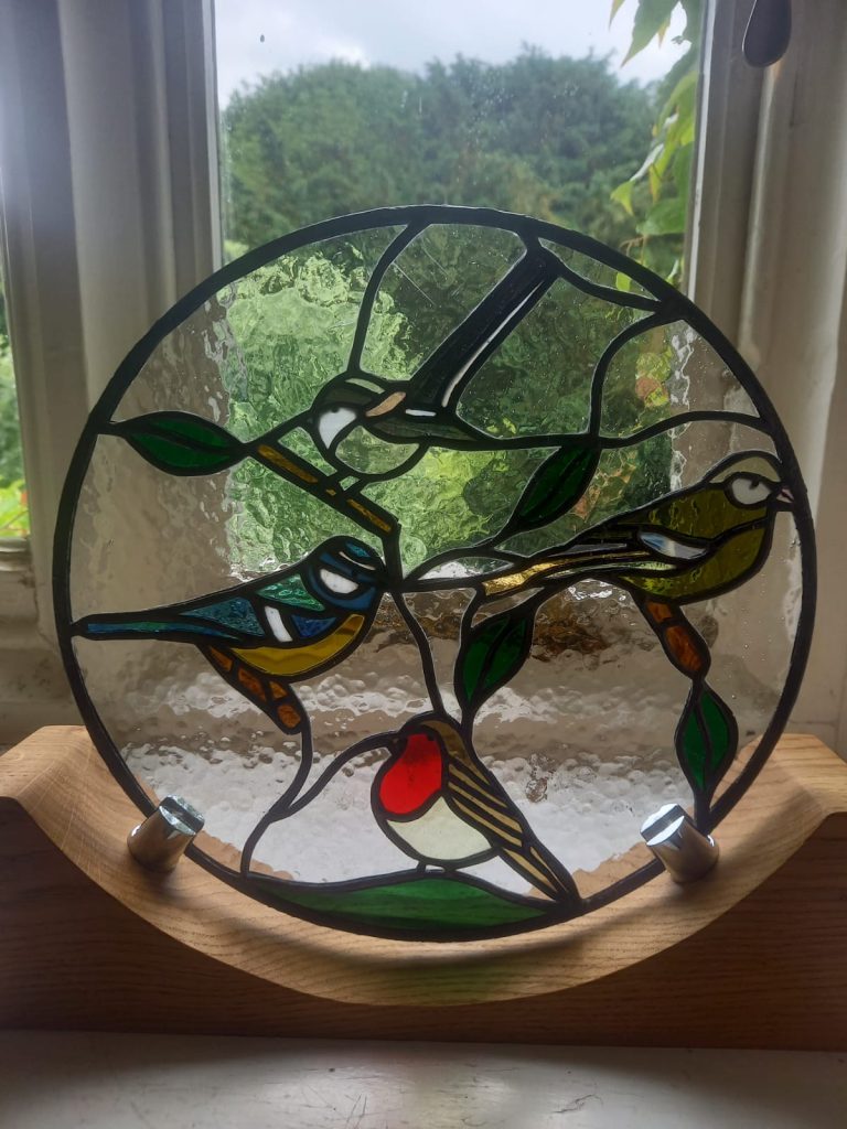 Commission stained glass circular garden birds