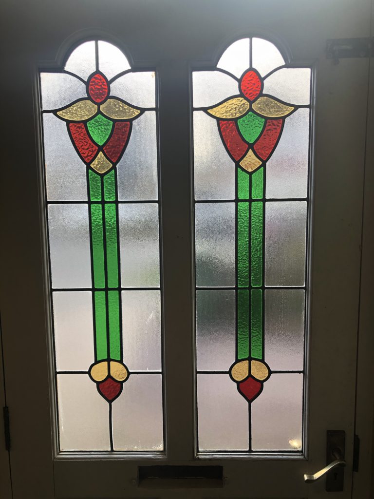 Commission stained glass door panels arched tulip red green