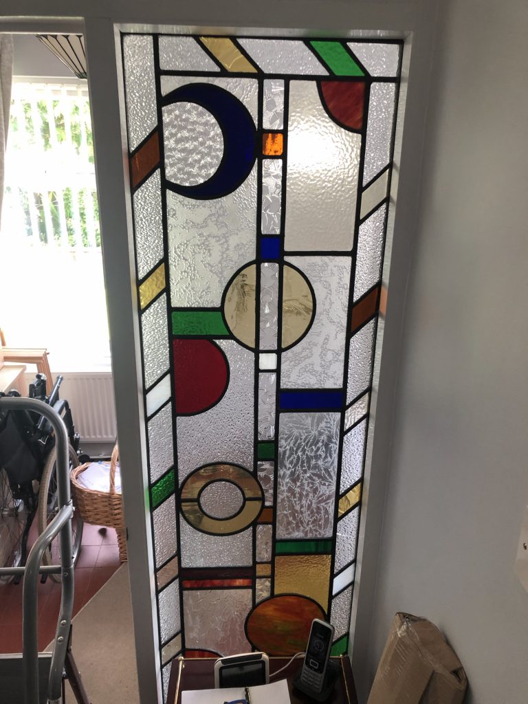 Commission stained glass panel geometric bold circles tall