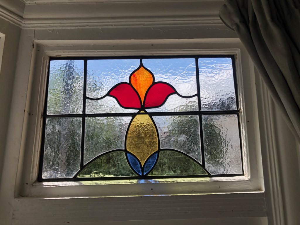 Commission stained glass window arched red tulip bud