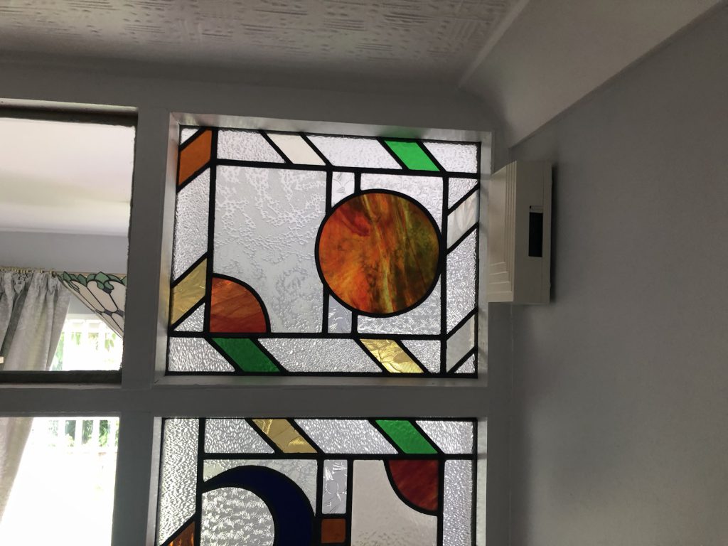 Commission stained glass window geometric circles amber detail