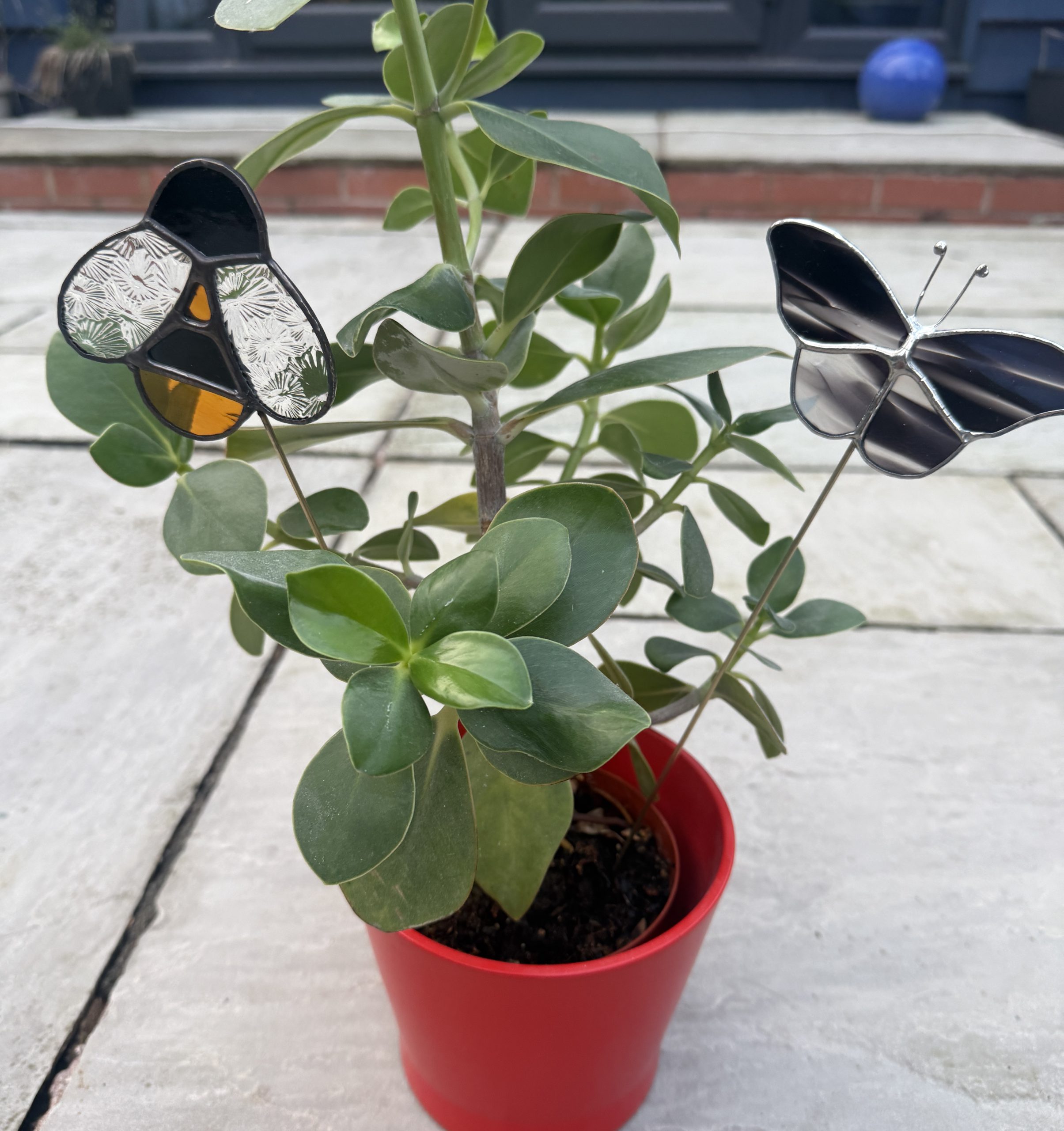 Stained glass butterfly plant stakes in a pot