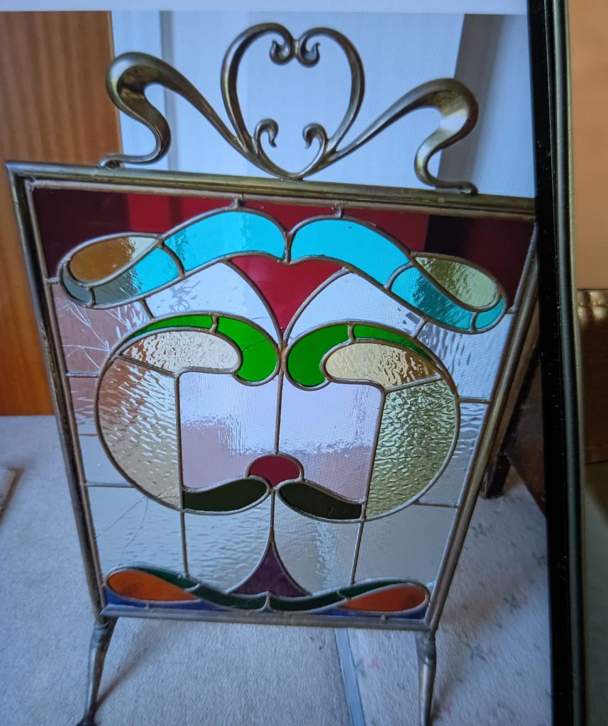 Stained glass abstract face firescreen