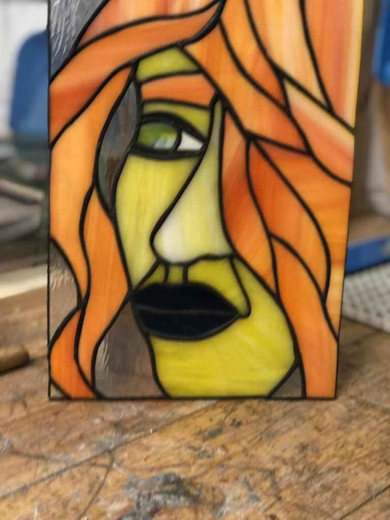 Stained glass abstract face orange hair