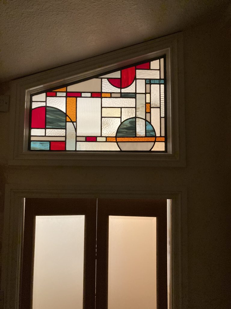 Stained glass art deco transom window installed