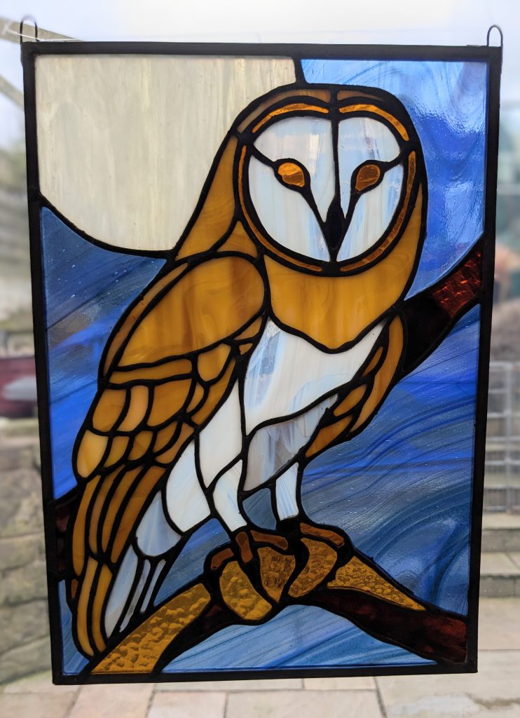 Stained glass barn owl golden blue