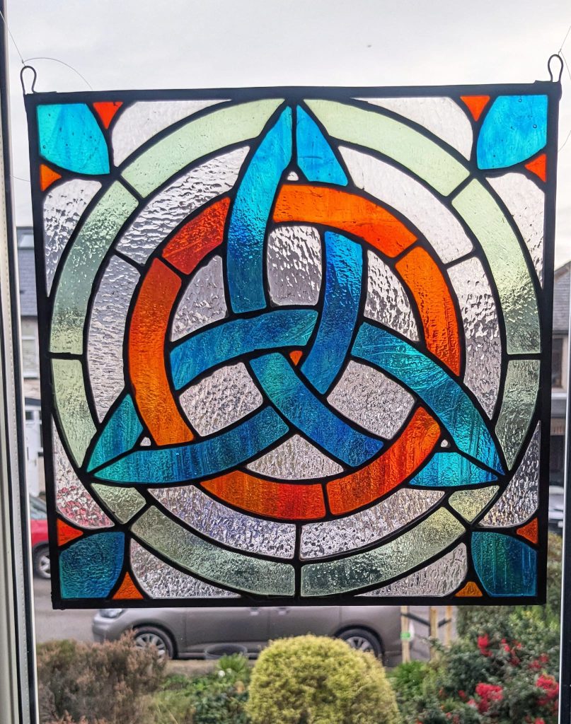 Stained glass celtic trinity knot teal orange