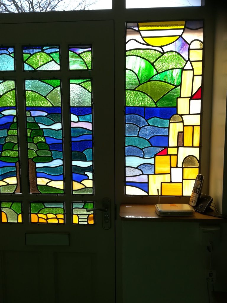 Stained glass coastal door village installed
