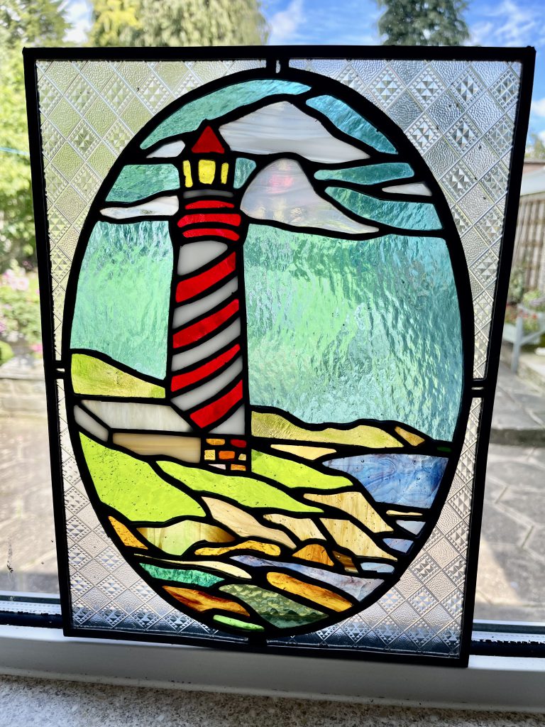 Stained glass lighthouse oval red stripe panel