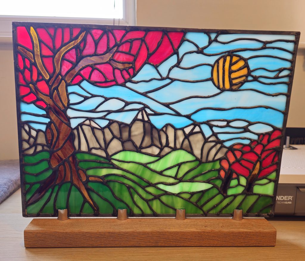 Stained glass mountain landscape red tree panel