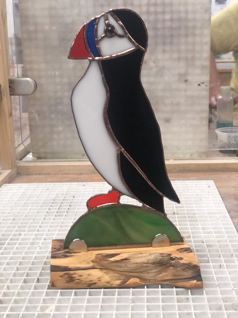 Stained glass puffin sculpture wood stand