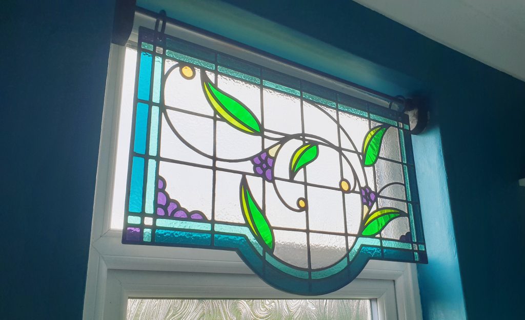 Stained glass thistle window installed