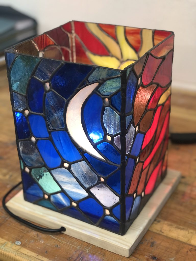 Stained glass tiffany moon lamp lit blue