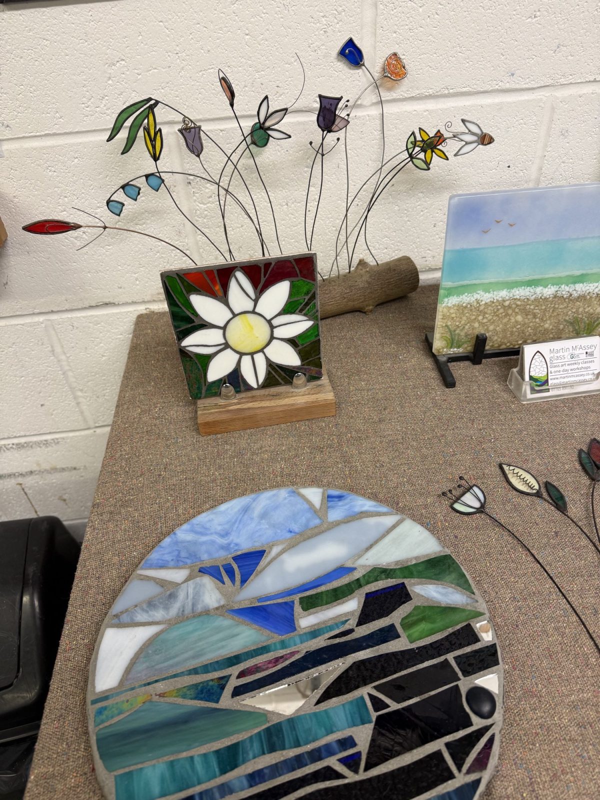 Student cutting glass during a stained glass workshop at Martin McAssey Glass Studio