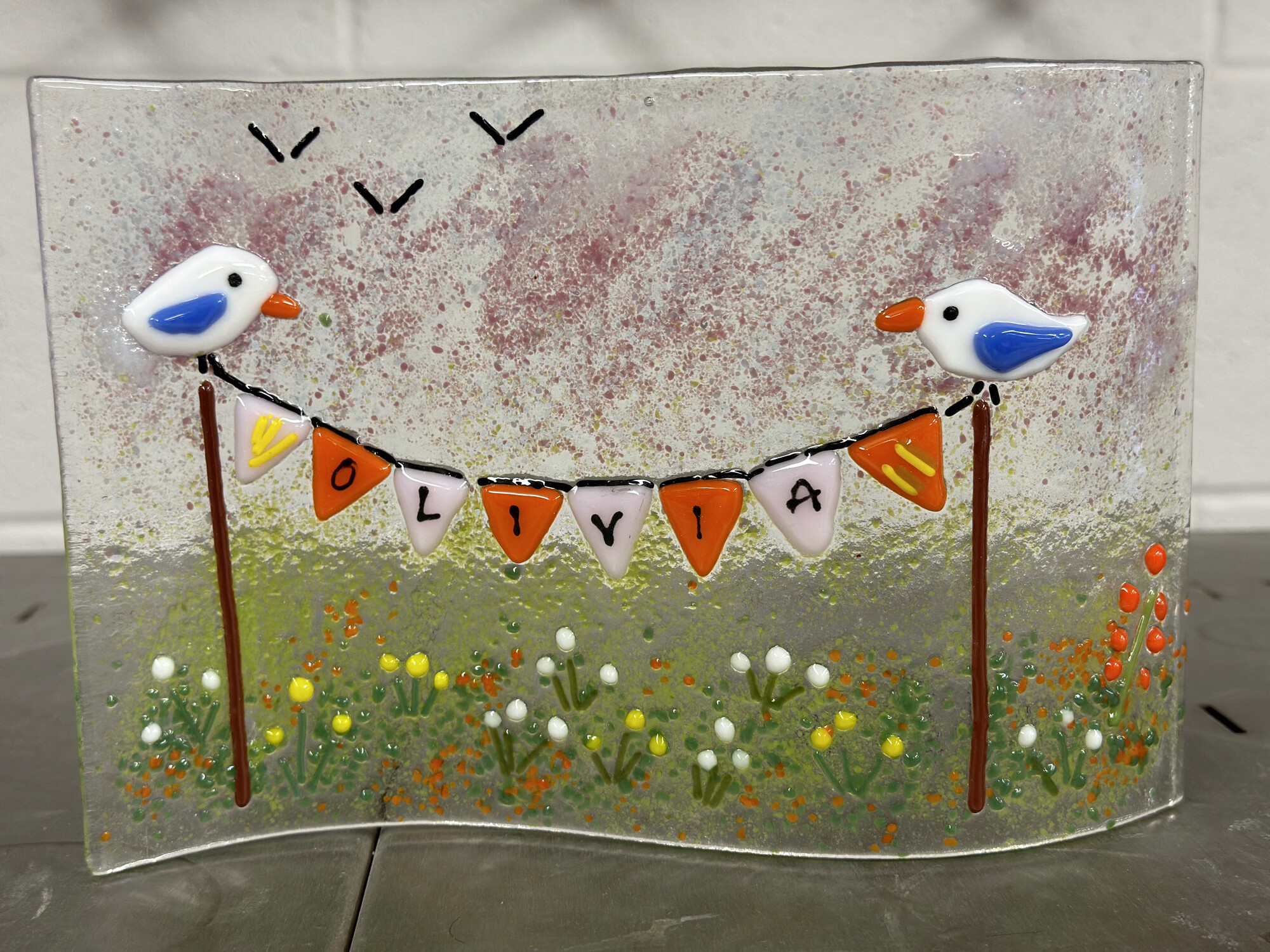 Student fused glass panel with birds and bunting