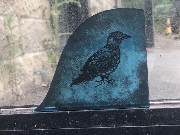 Student painted glass crow raven teal shaped