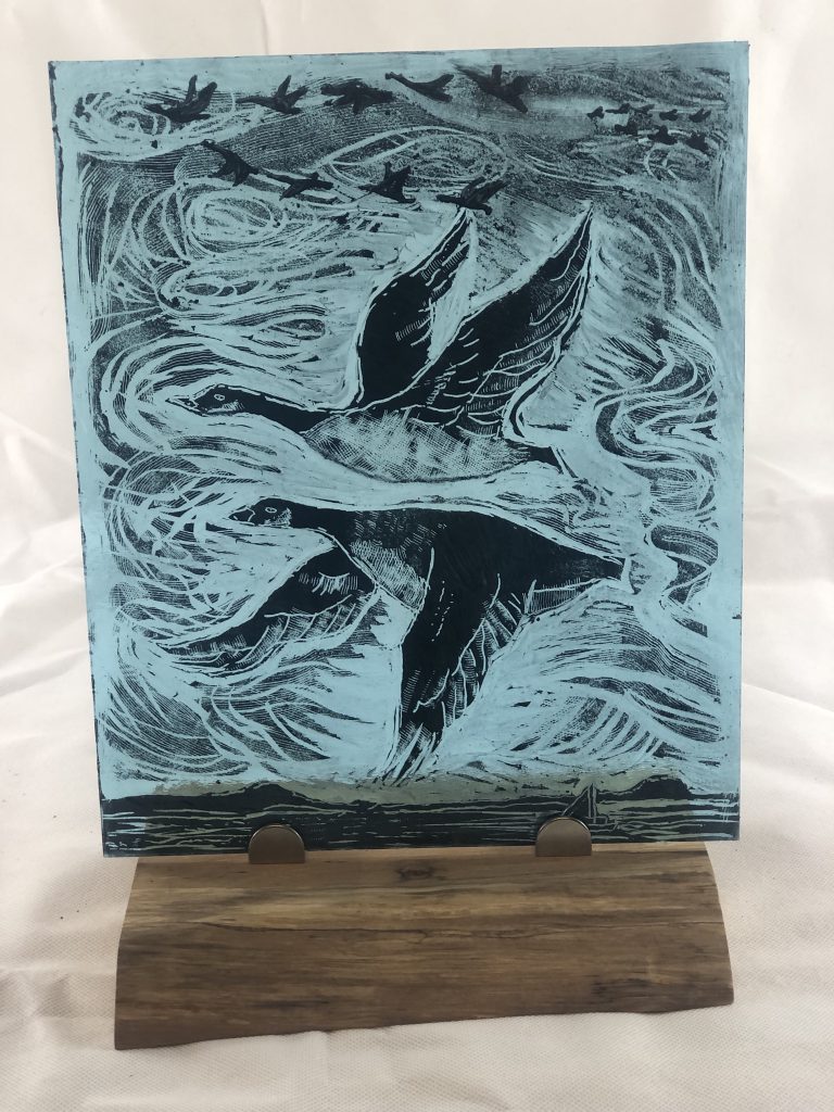 Student painted glass geese flying storm teal