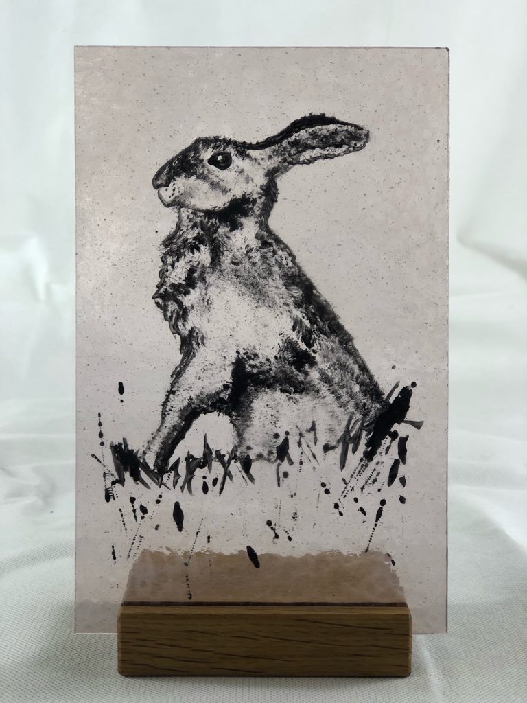 Student painted glass hare jumping pink grey