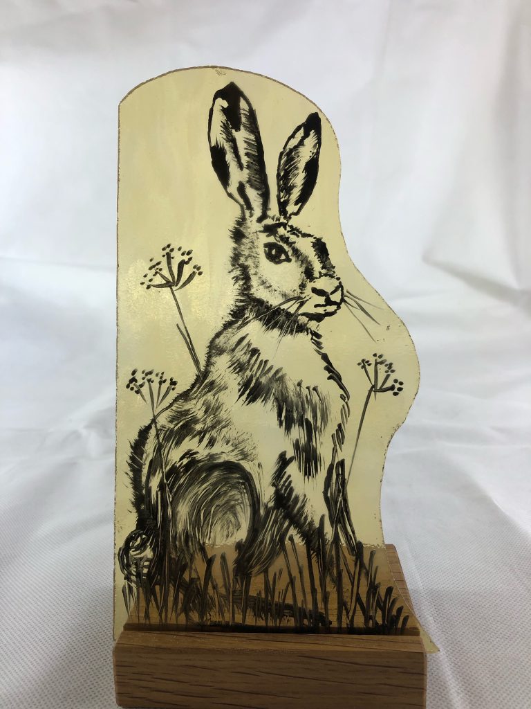 Student painted glass hare meadow amber shaped