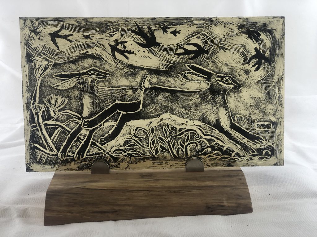 Student painted glass running hares scratchboard