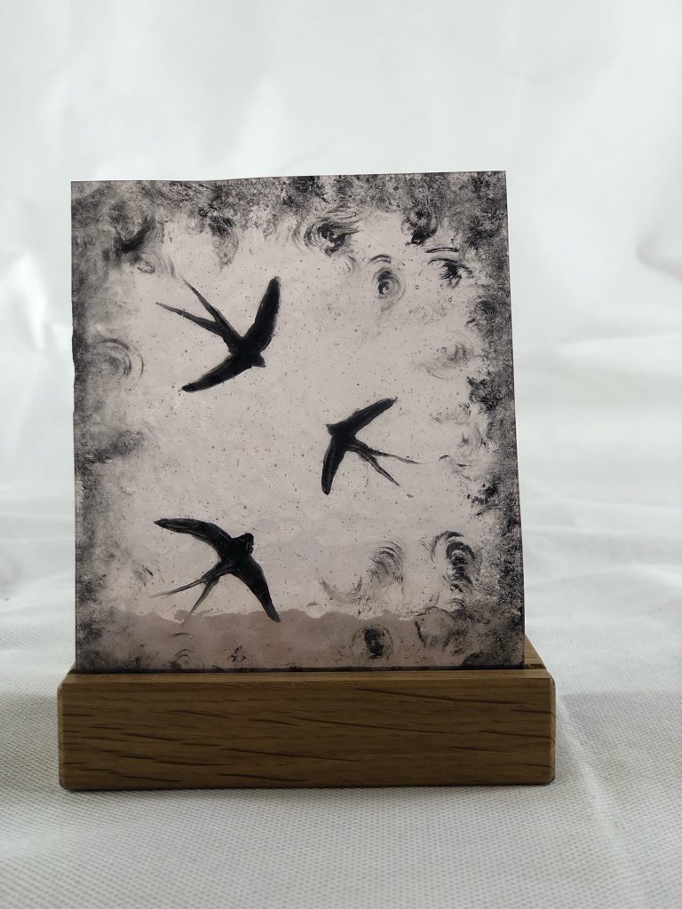 Student painted glass swallows flying monochrome