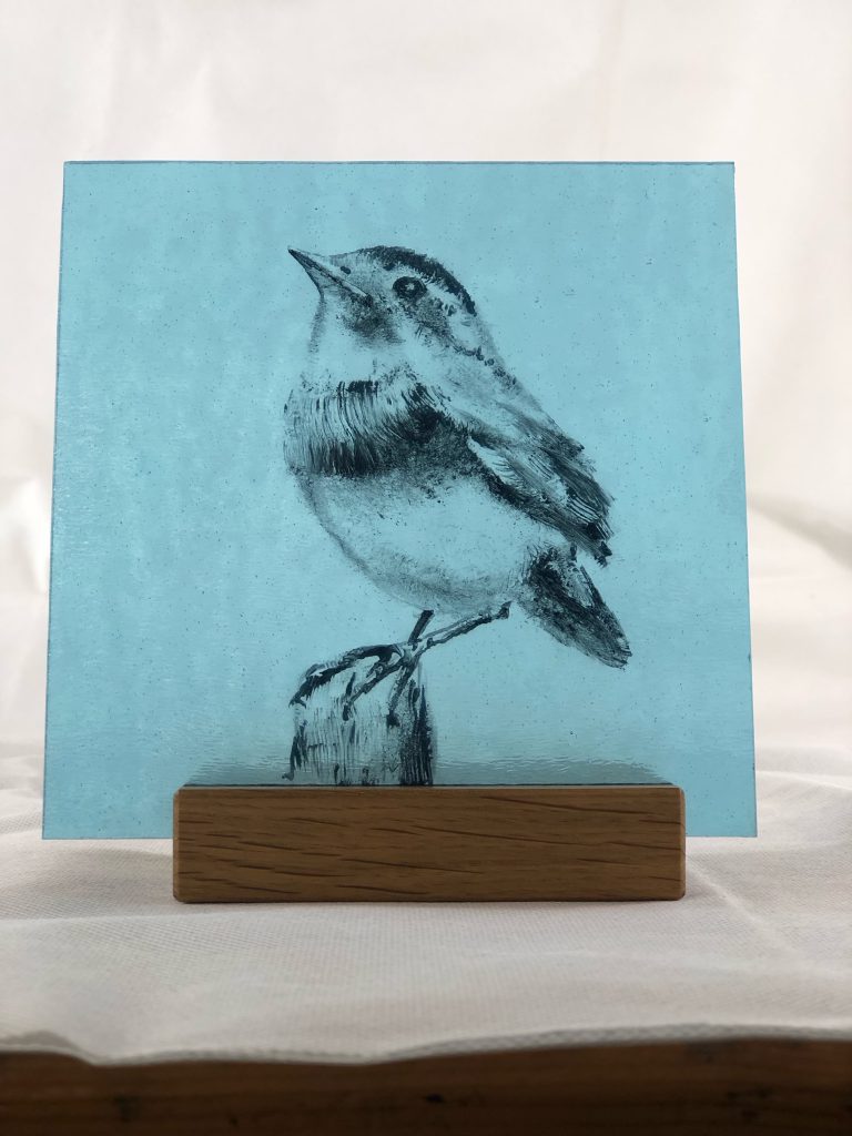 Student painted glass wren teal