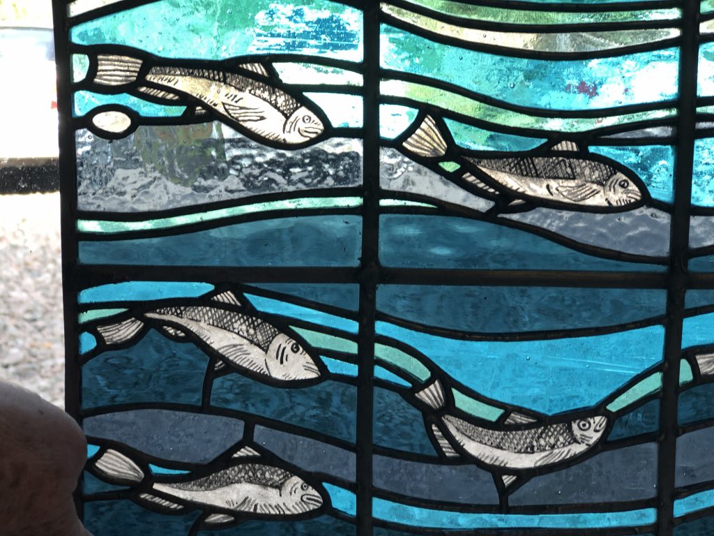 Student stained glass fish swimming teal waves wide