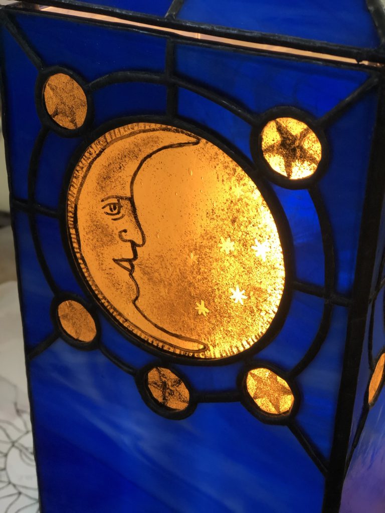 Student stained glass lamp celestial moon face detail