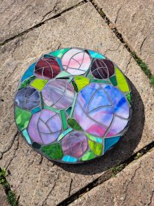 Student mosaic stepping stone with blue and purple tulips