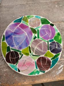 Student mosaic stepping stone with pink and purple tulips