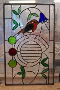 Student stained glass window with robin and celtic design